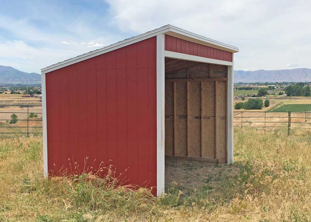 An 8 by 14 foot lean-to loafing shed in red and white