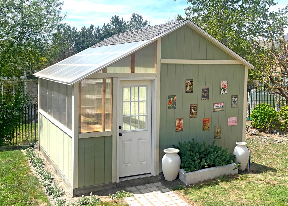 A custom shed with a lean-to greenhouse attached to the side