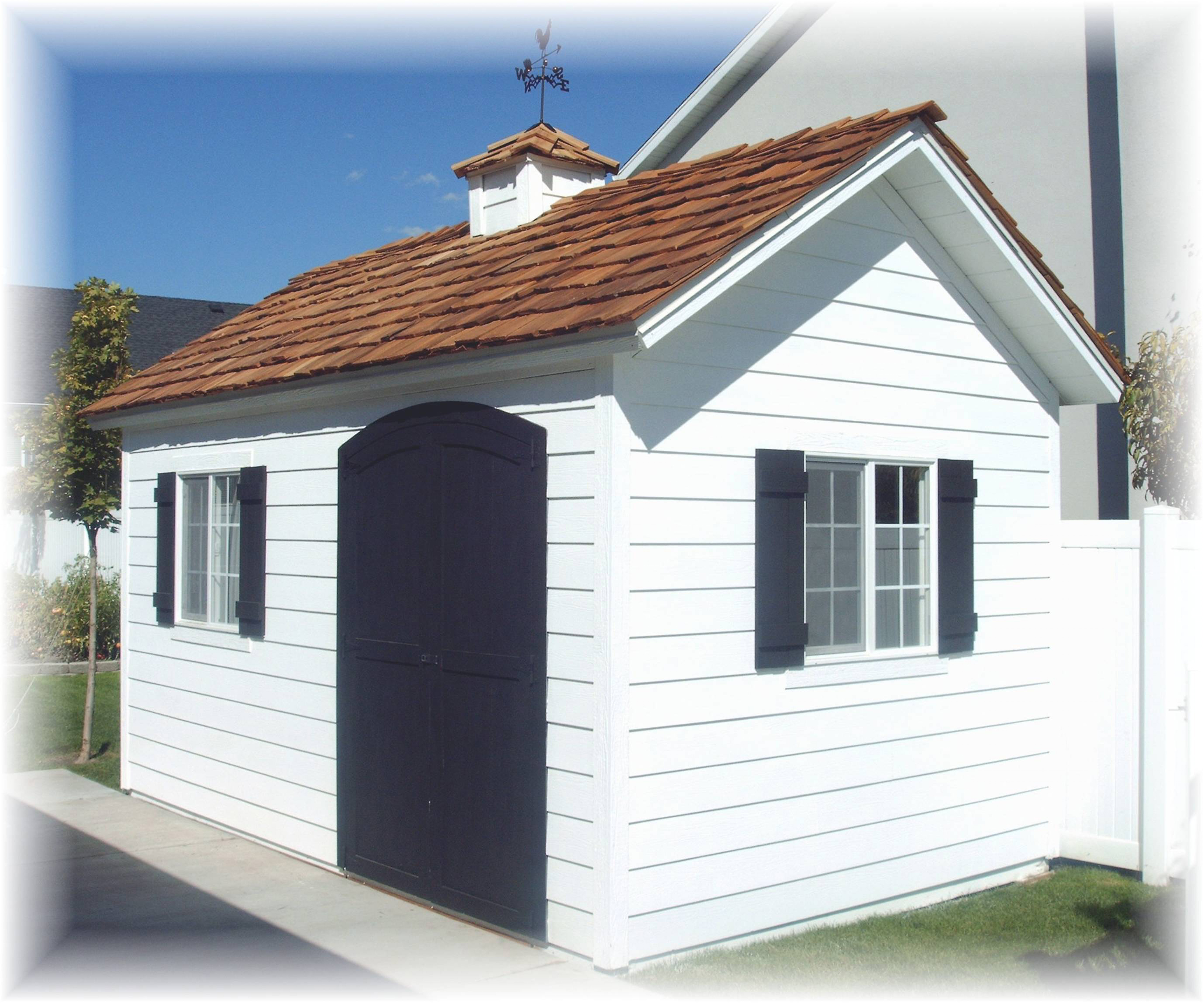 Custom 8 foot by 16 foot Tall Apex with Lap siding, cedar shake shingles and a cupola with a weathervane.