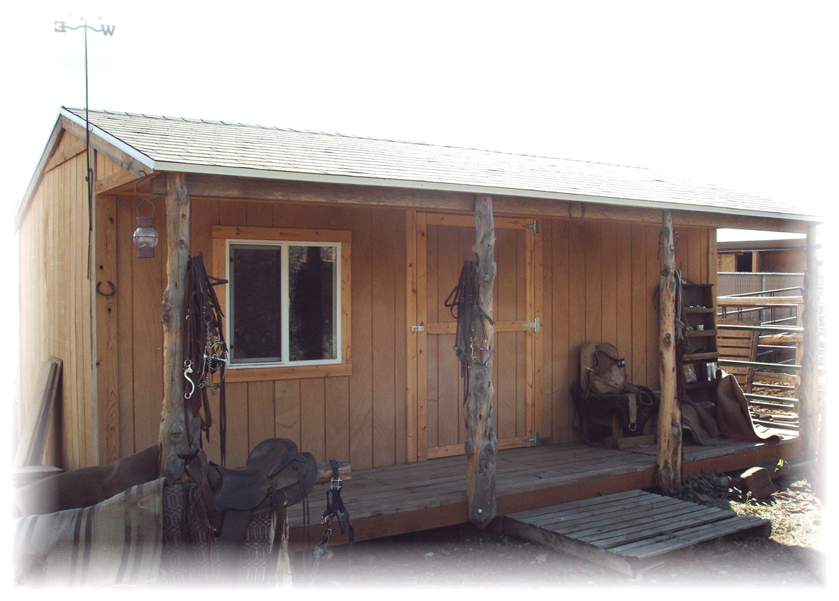 A 14 foot by 20 foot Tack Style Shed with natural wood siding and cedar fence porch posts